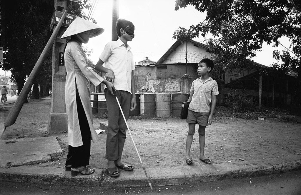 Saigon 1972 - People who have turned blind because of the war learn to cross a road.